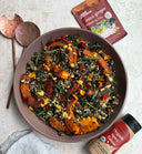 Roasted squash, kale and farro salad with pumpkin seeds, dates and flower petals, beside Salad for President Miso Ginger Dressing Mix and Seed + Mill Organic Spicy Tahini.